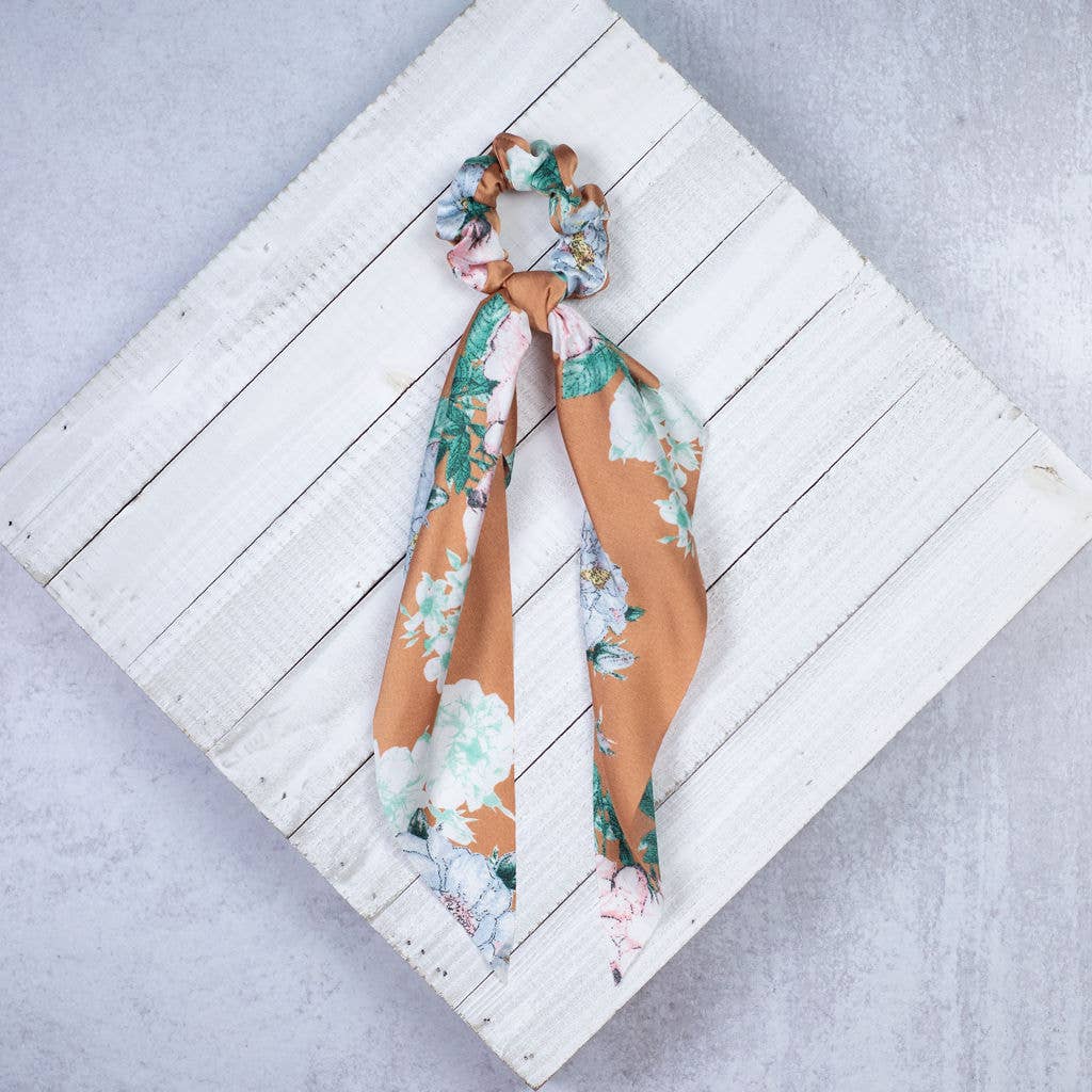 Add some fun and flair to your ponytails and buns with these adorable floral print hair scarves by Lauren Lane. Explore the best and coolest gift ideas for plant enthusiasts!